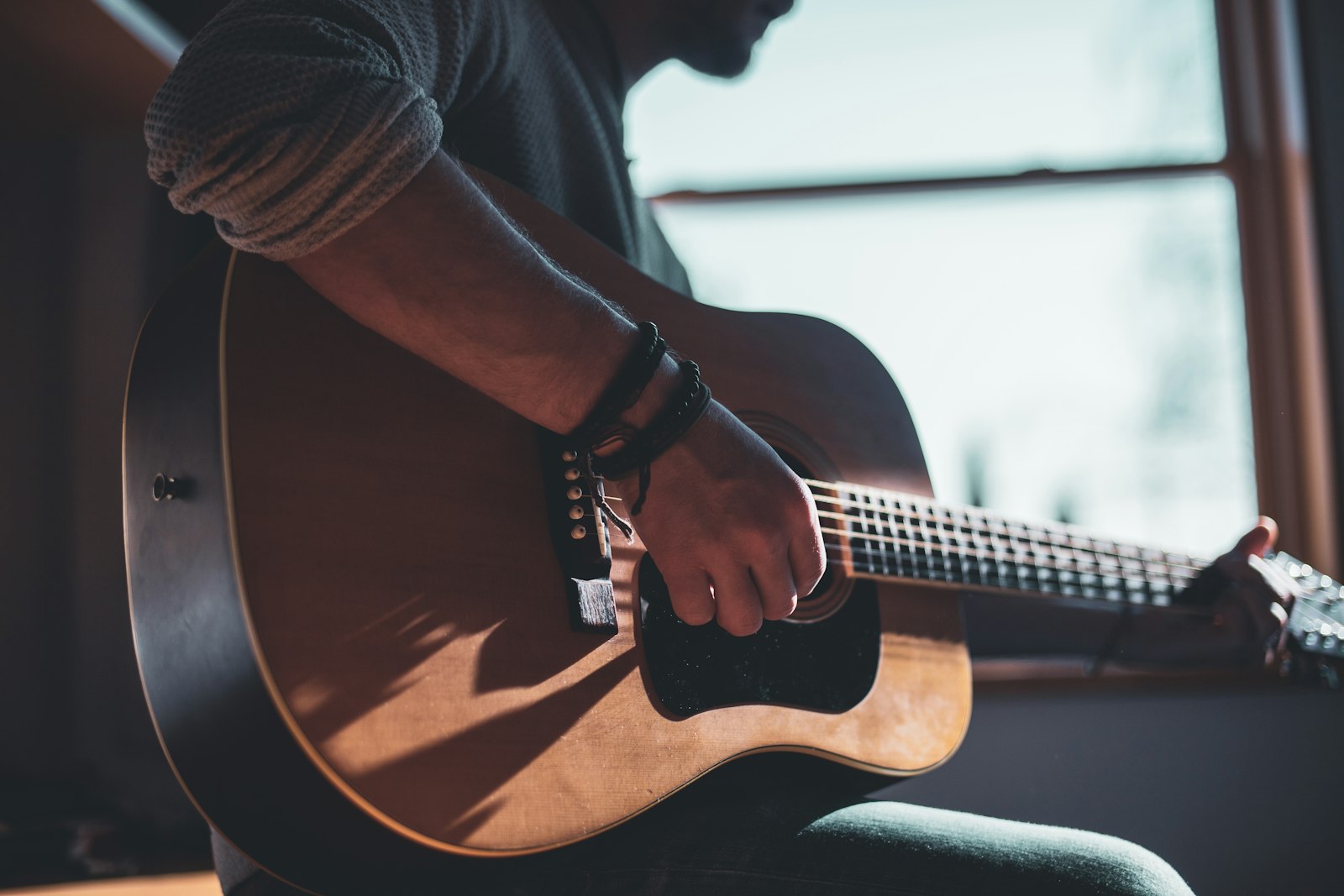 Musician playing acoustic guitar